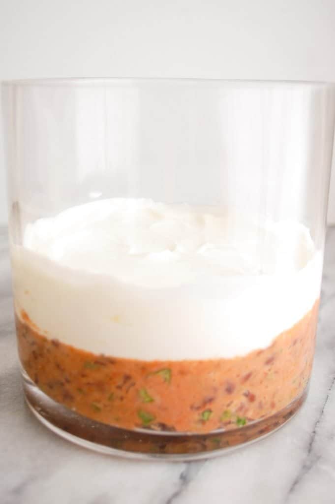beans and greek yogurt in jar for seven layer dip