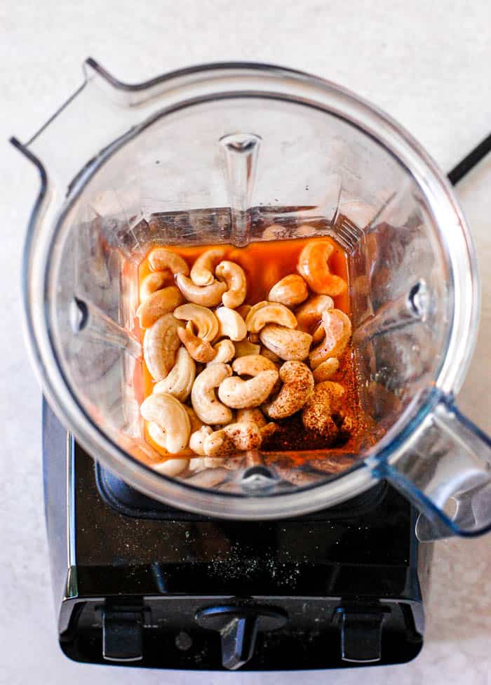 cashews, buffalo sauce, chili powder in a vitamix