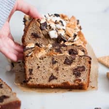 hand grabbing slice of smores banana bread