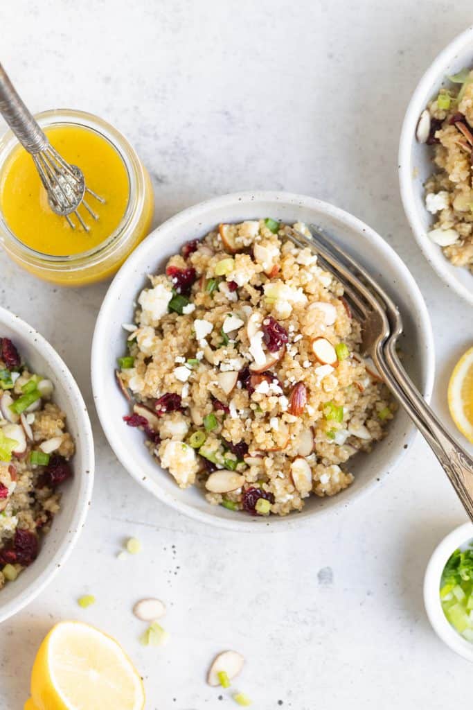 cranberry quinoa salad in bowls with forks