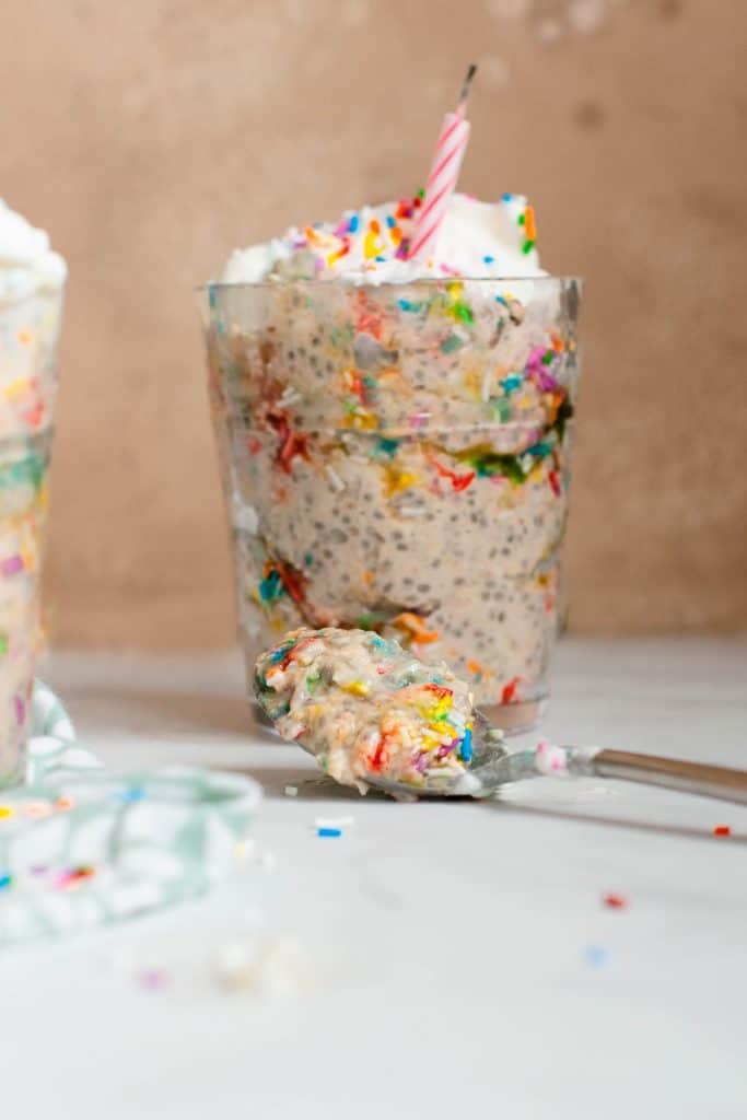 birthday cake overnight oats in cup with candle
