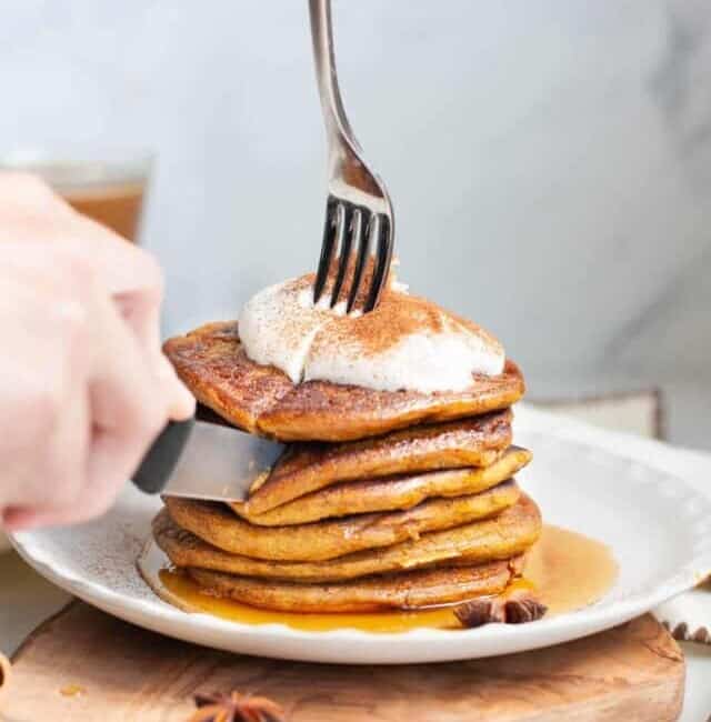 Pumpkin Pancakes being cut with knife
