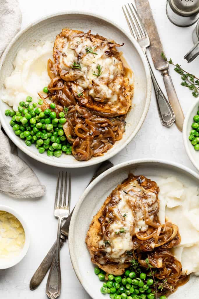 french onion chicken on two plates with peas