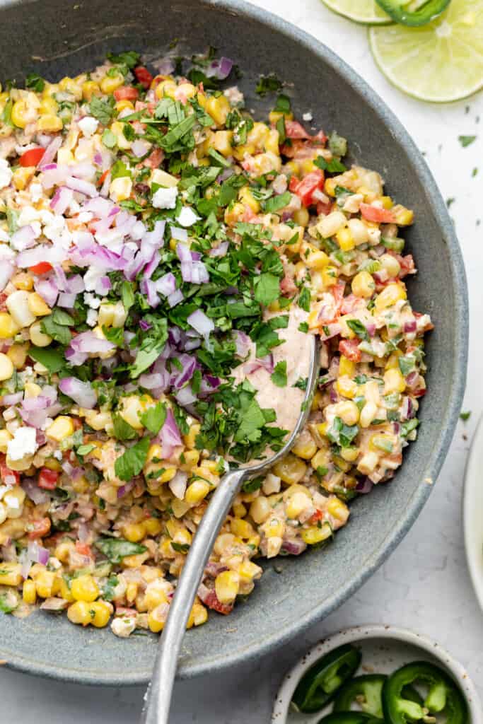 corn salad in a bowl with a spoon