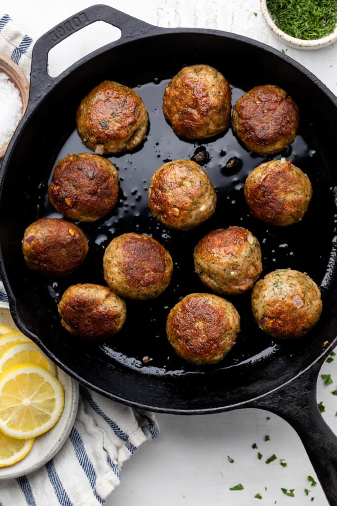 meatballs cooking in pan with oil