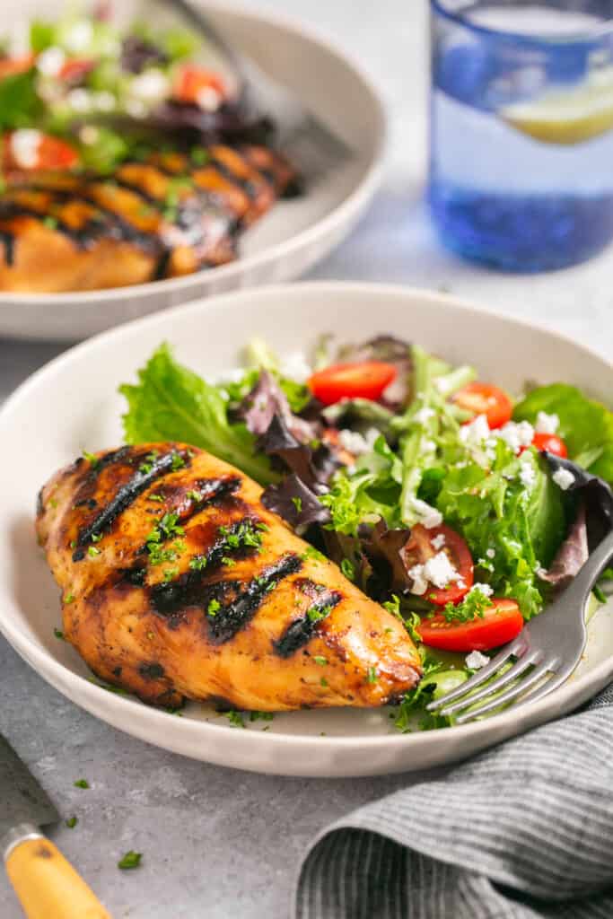 grilled chicken on plate with salad