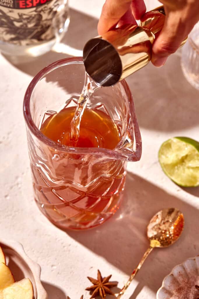 pouring liquor into cocktail glass