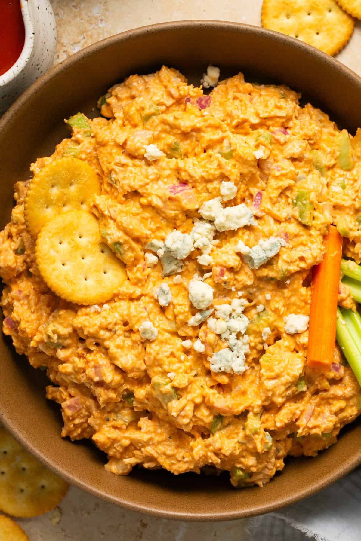 buffalo chicken salad in bowl with crackers