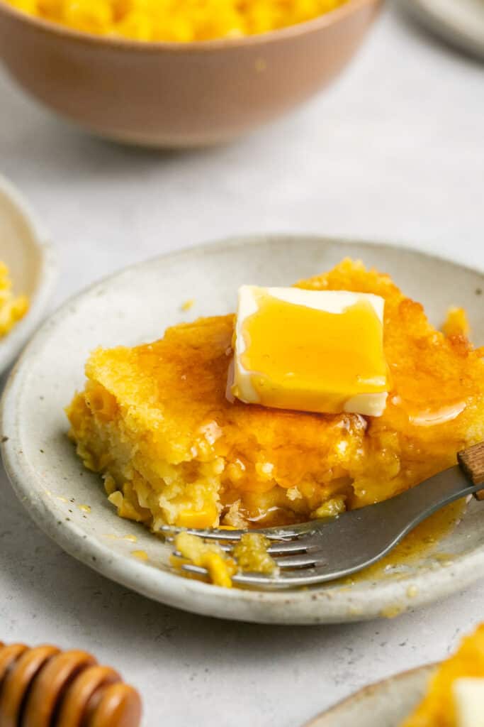 corn pudding on plate with butter