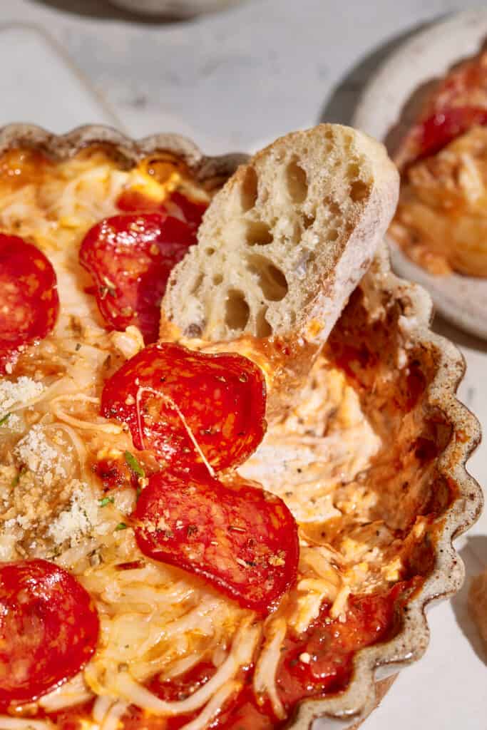 bread in pizza dip with pepperoni