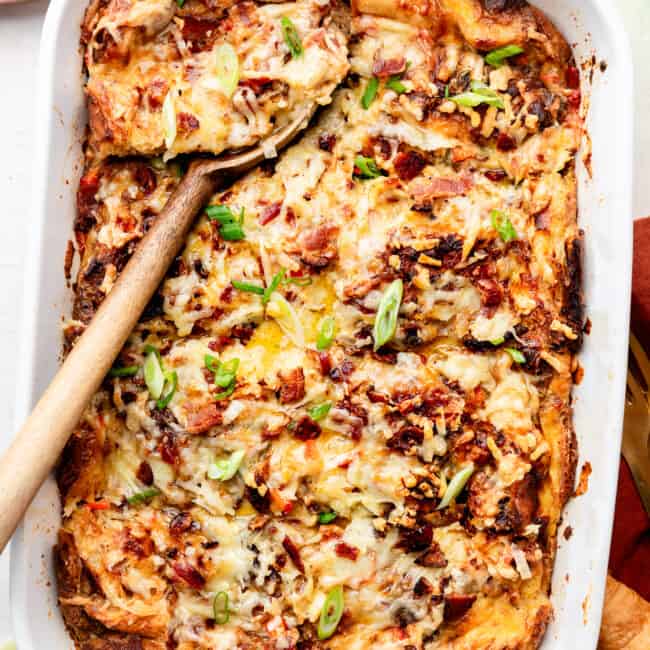 croissant breakfast casserole baked with wooden spoon