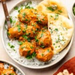 butter chicken meatballs in bowl with naan