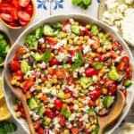 Mediterranean Chickpea Salad in bowl with wooden spoons