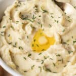 mashed potatoes in bowl with butter and chives