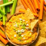 Crockpot Buffalo Chicken Dip in bowl with carrots, celery and chips