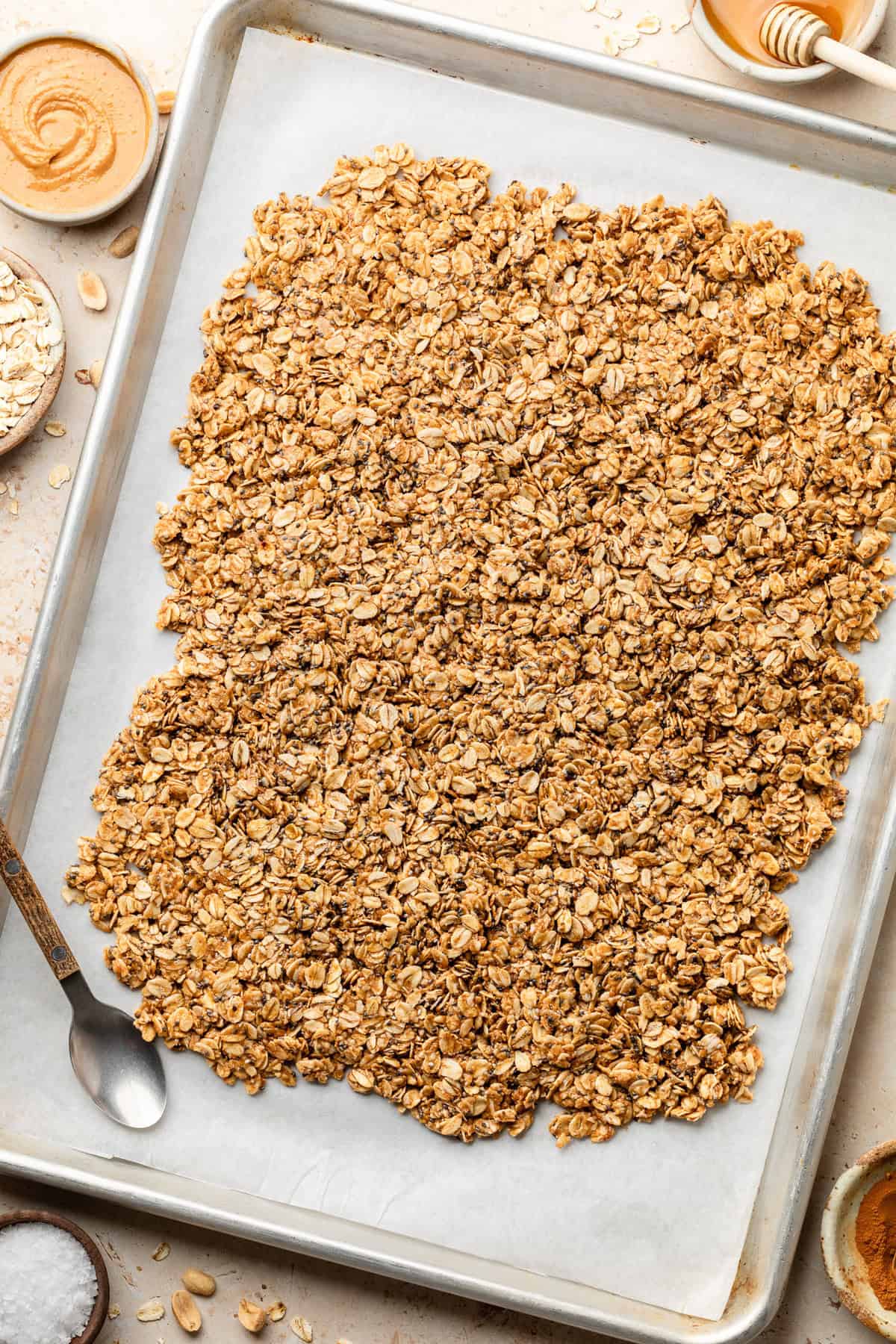 Peanut Butter Granola on parchment paper on baking sheet