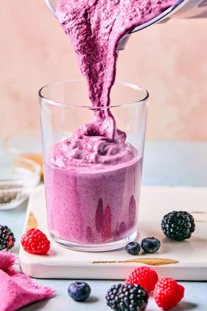 Pouring the Berry Protein Smoothie in cup