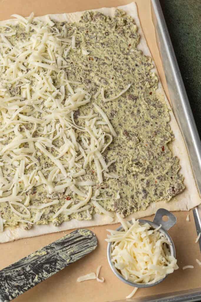 Puff pastry with sausage mixture and cheese on top
