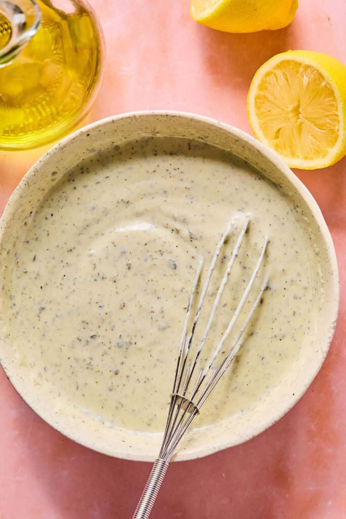 Dressing in bowl with whisk
