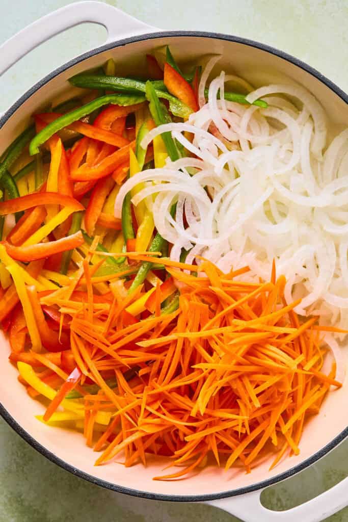 peppers, onions and carrots in pot