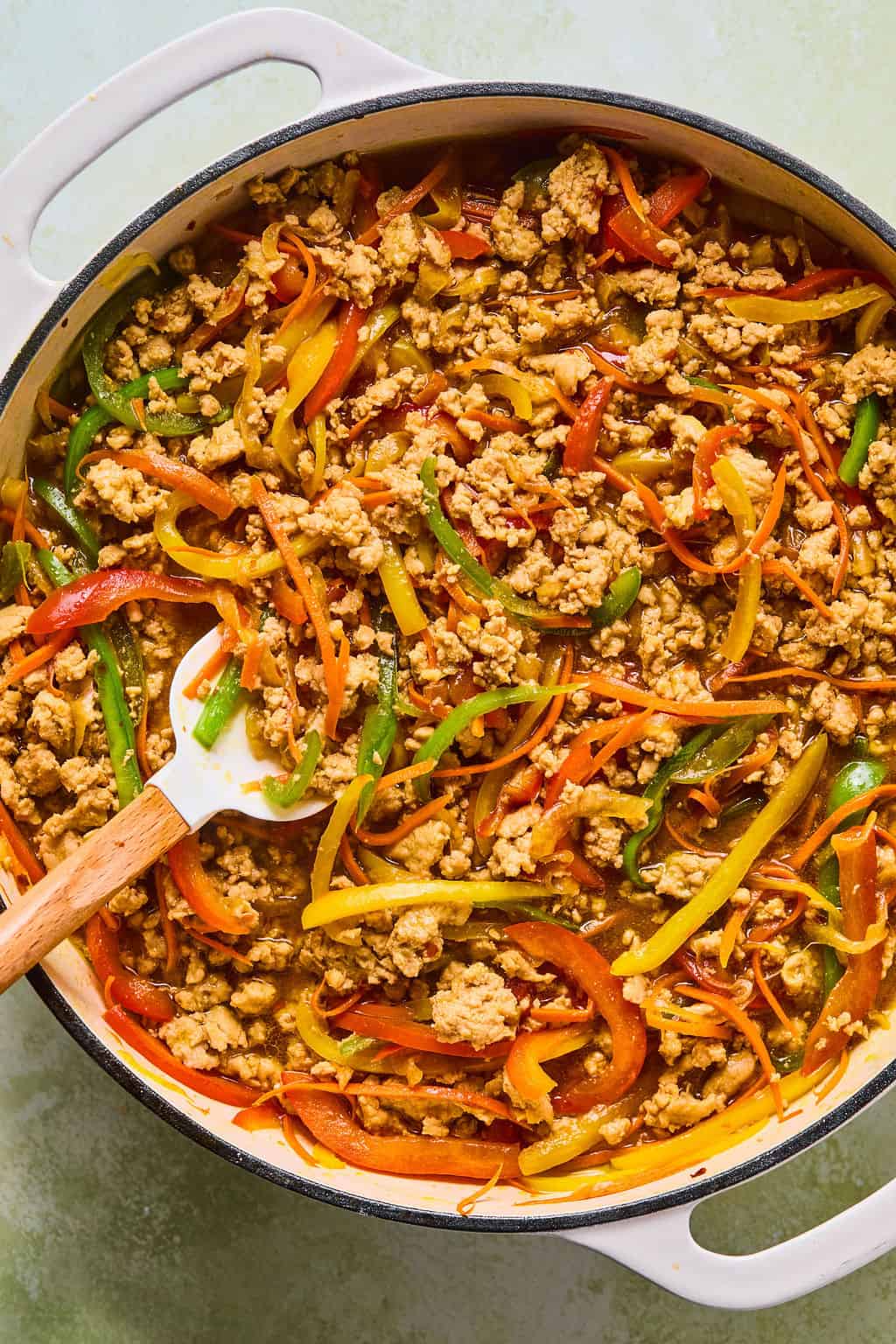 chicken, peppers, onions and carrots in pot