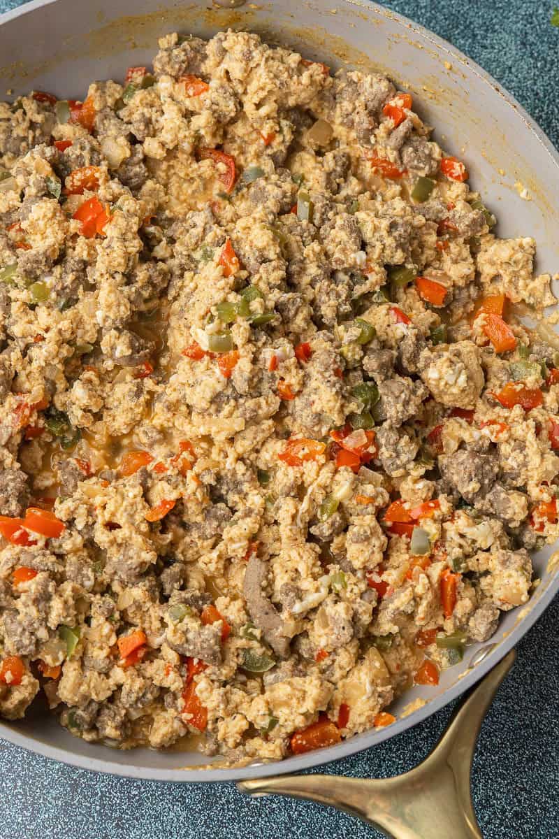 Ground turkey sausage with onion and peppers in pan