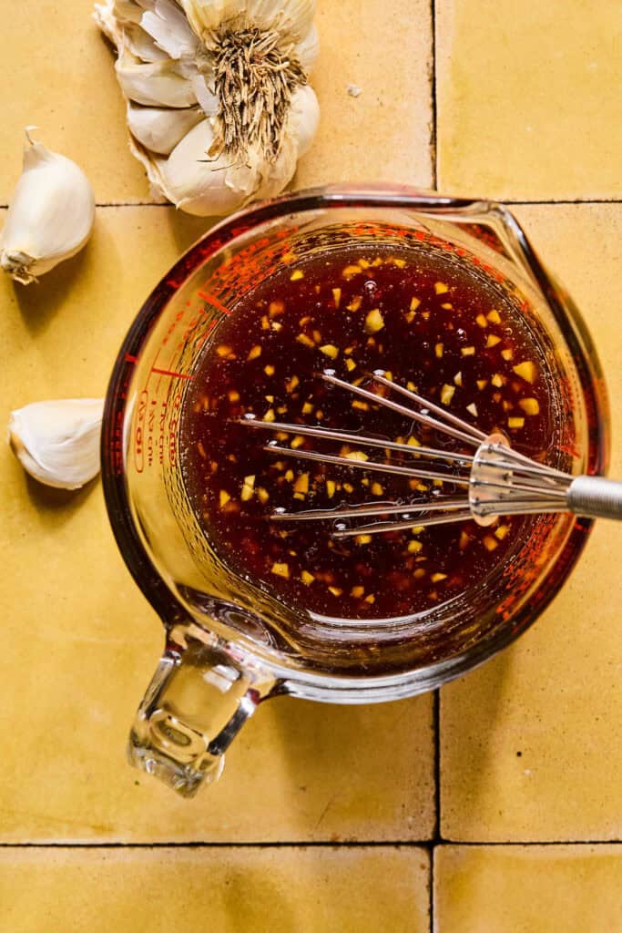 honey, soy sauce, chili sauce, sesame oil, rice vinegar, and garlic whisked together in measuring cup