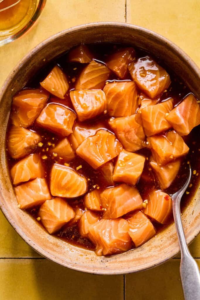 salmon cubes in mixture in bowl