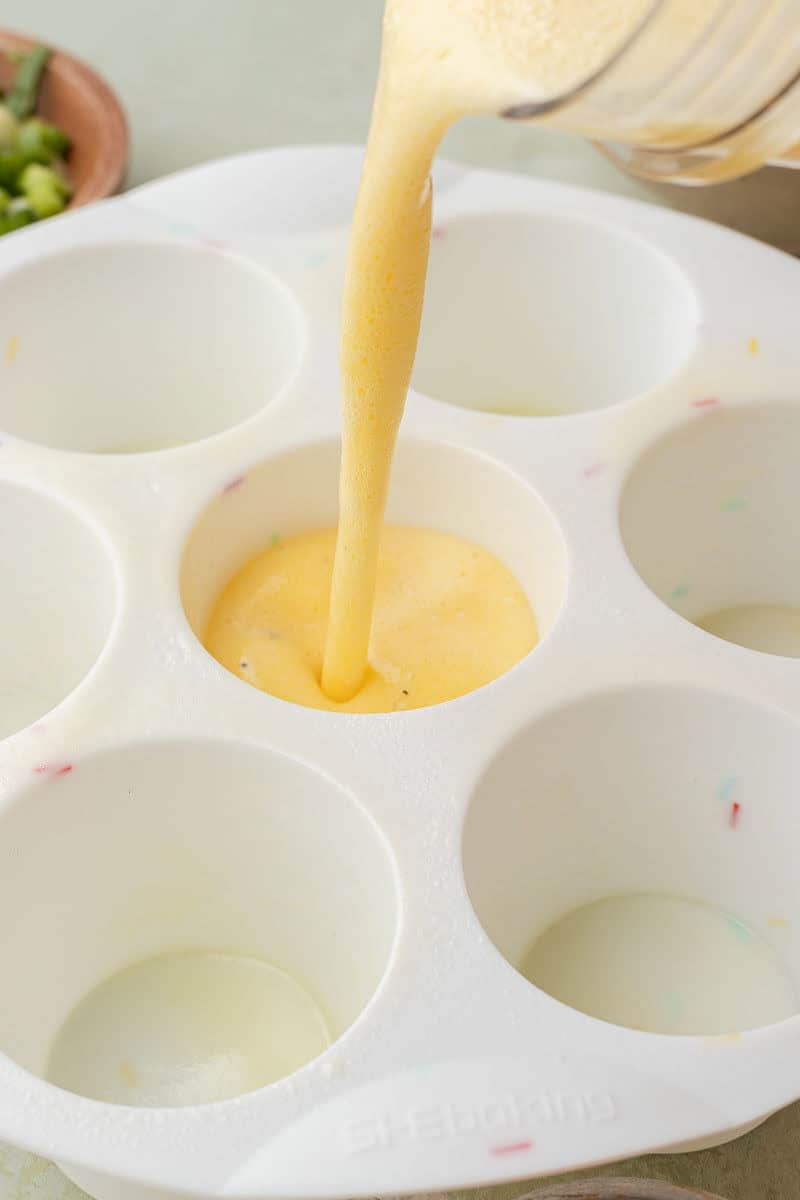 Pouring egg mixture into silicone egg mold