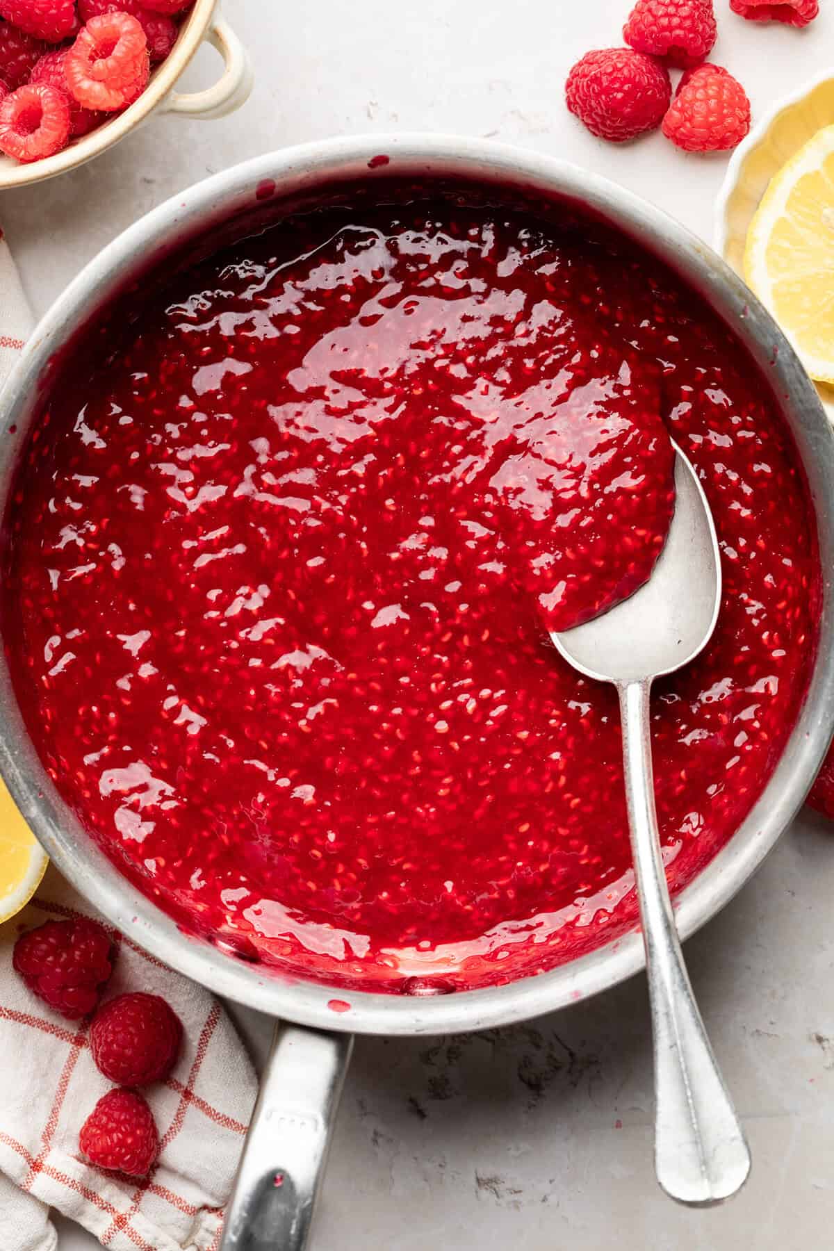 Saucepan with sugar, cornstarch, raspberries, lemon juice, and water