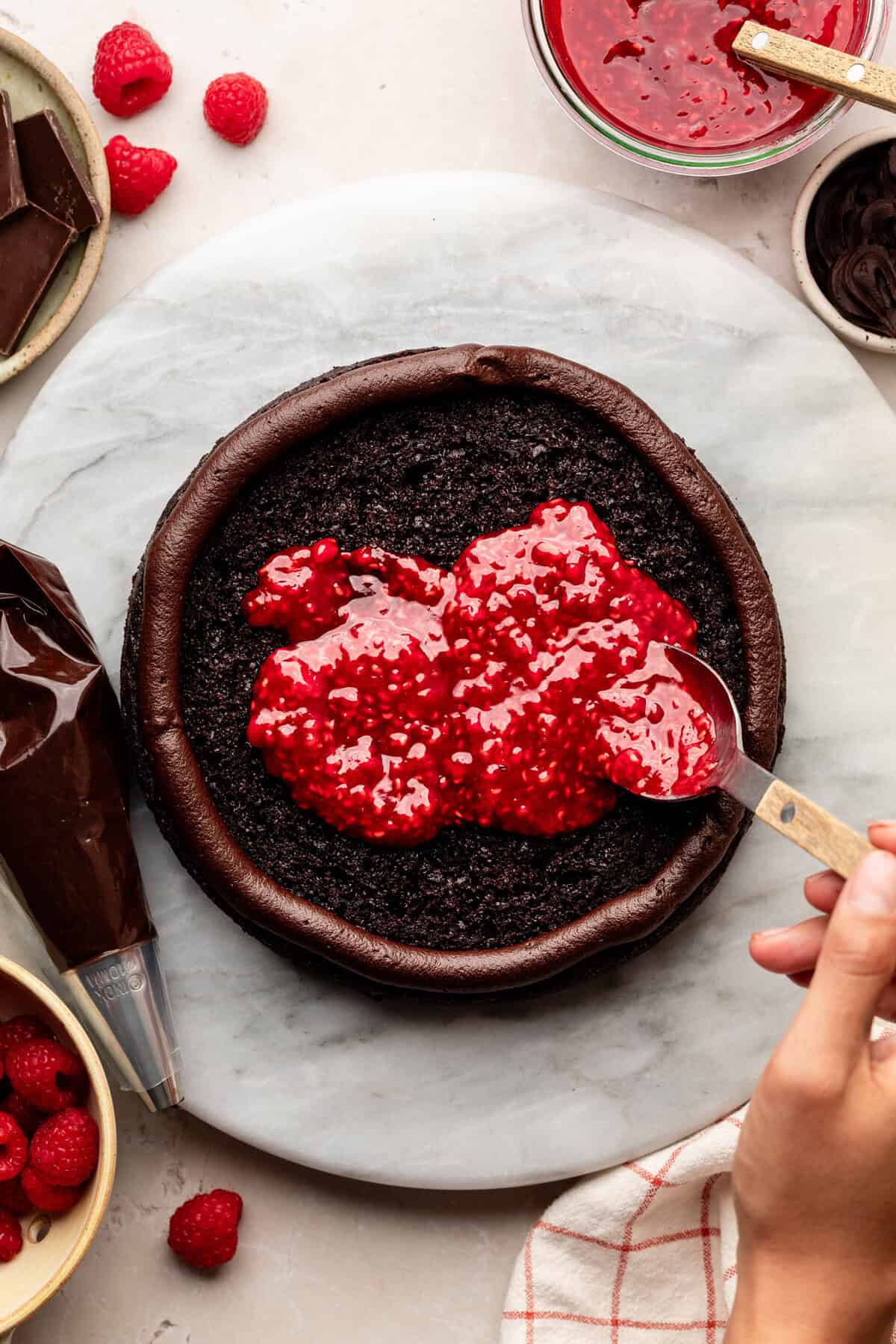 Adding raspberry filling to cake