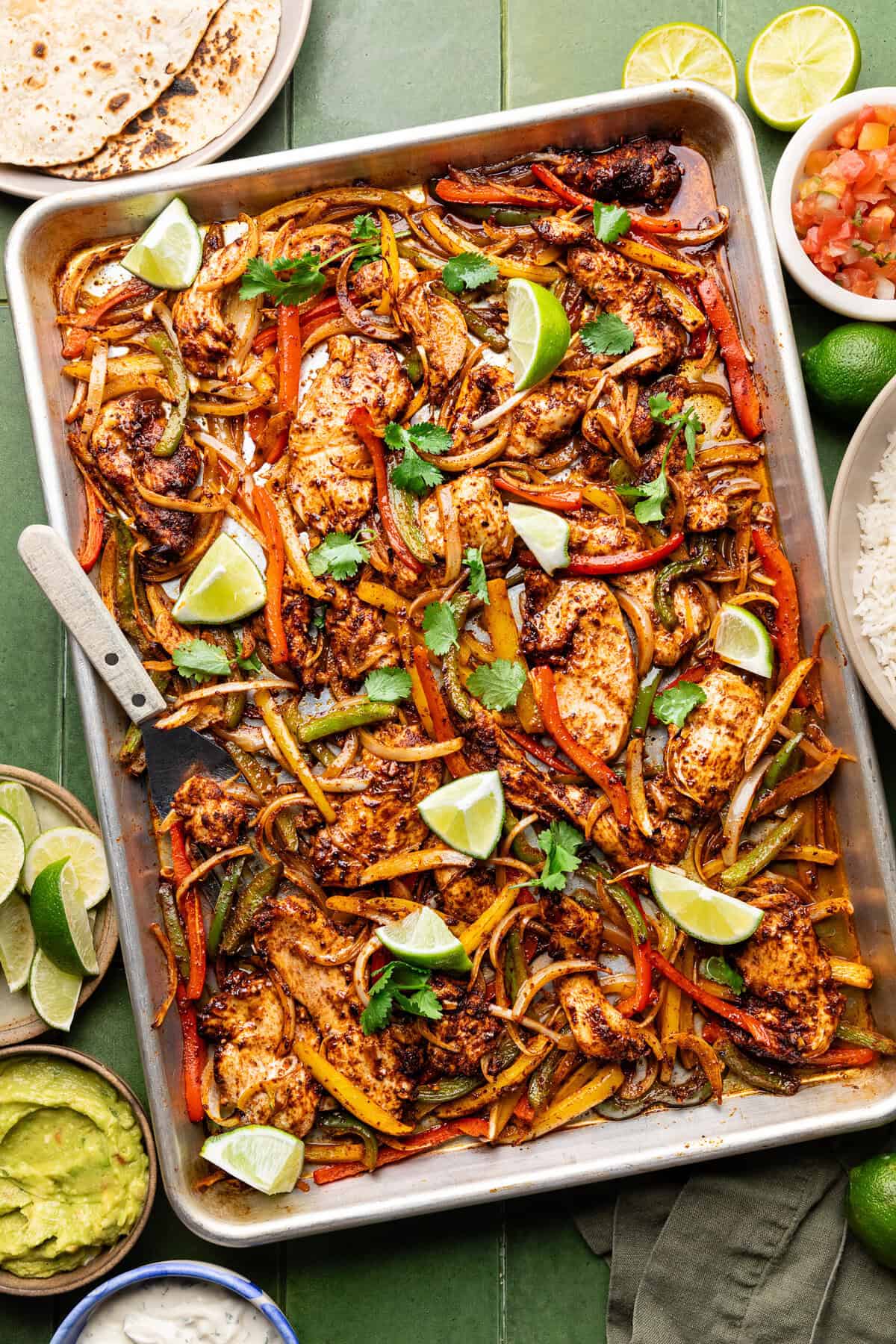 chicken and peppers and onions on a sheetpan