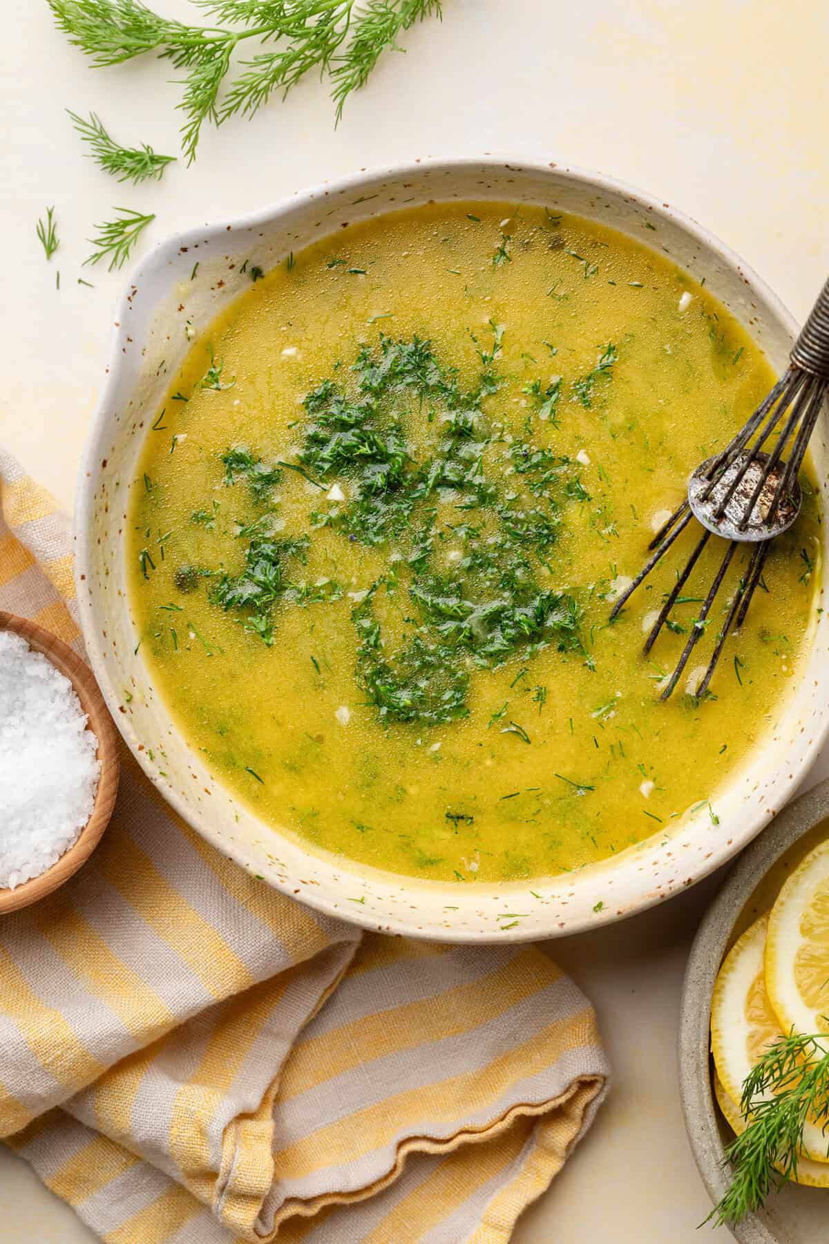 dressing in bowl with whisk.