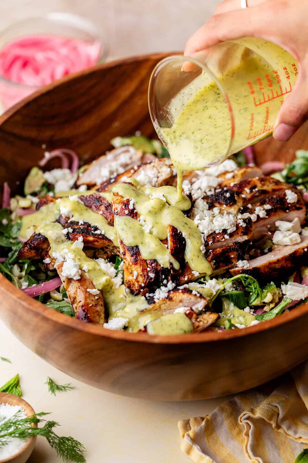 pouring dressing on salad