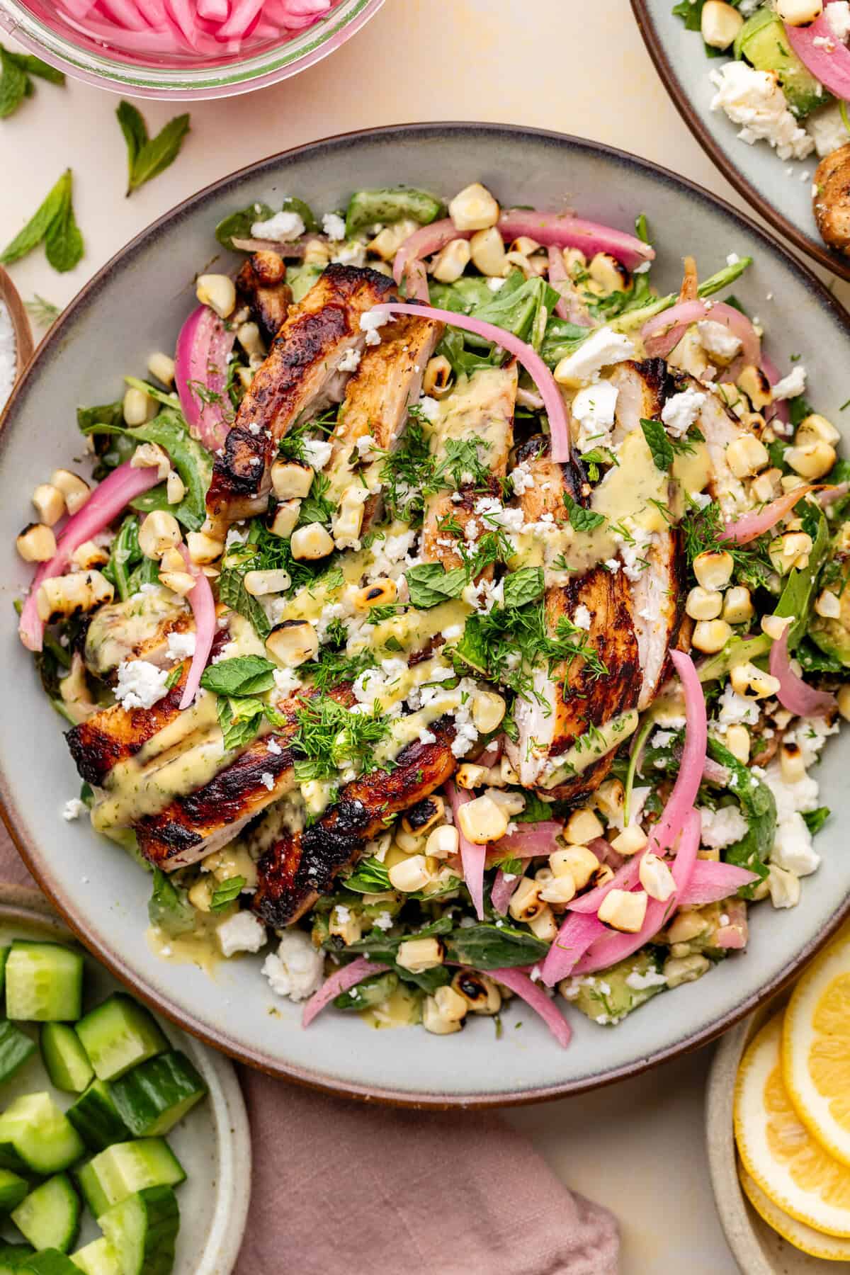 avocado-dill-feta-salad-9 Grilled chicken salad with charred corn, pickled red onions, fresh greens, herbs, and crumbled cheese drizzled with a yellow dressing