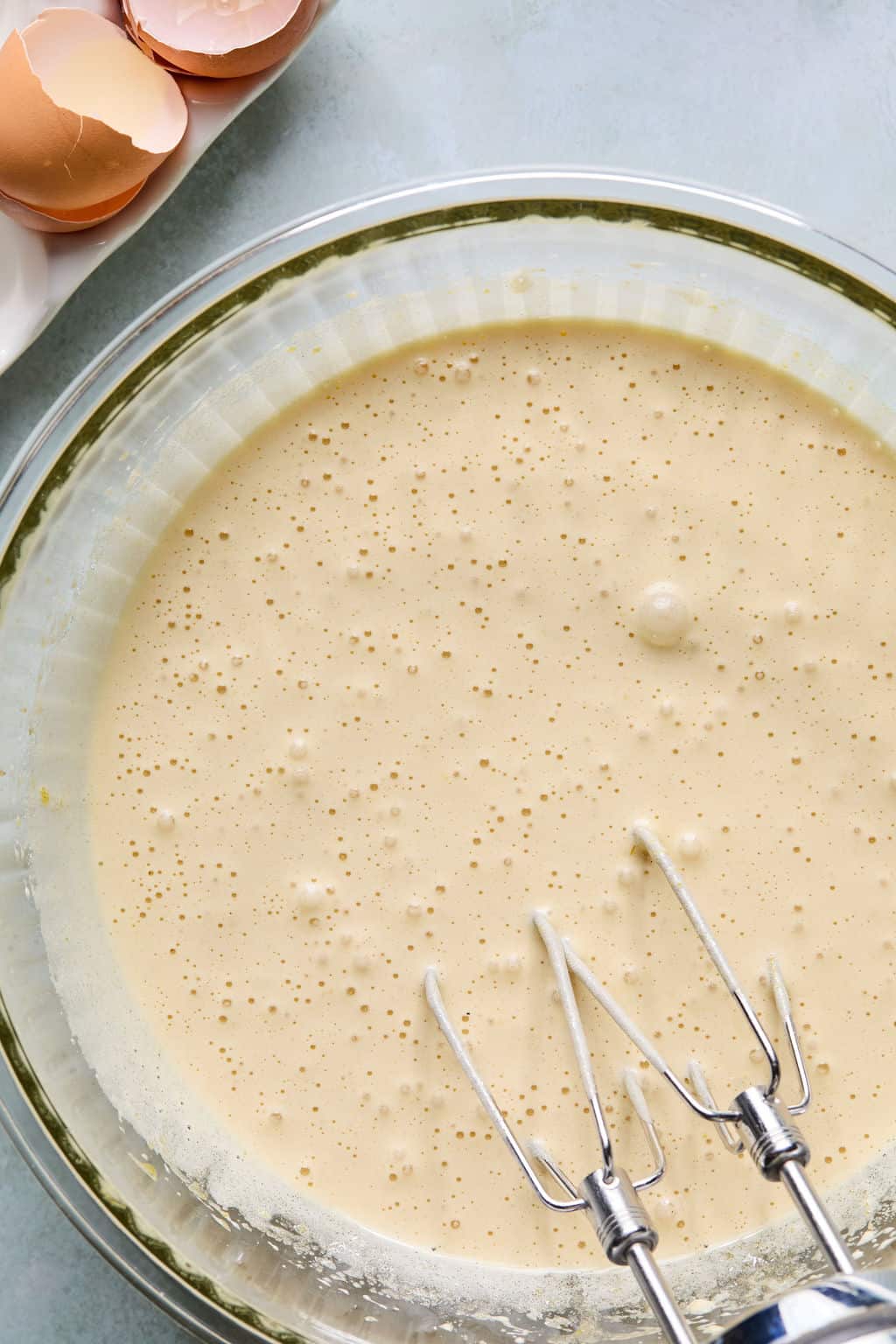 Bowl with white sugar, brown sugar, eggs, and vanilla mixed together.