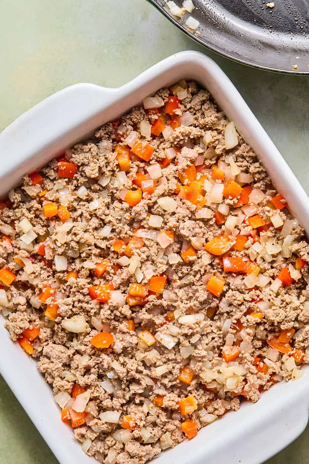 Turkey sausage and onions in pan.