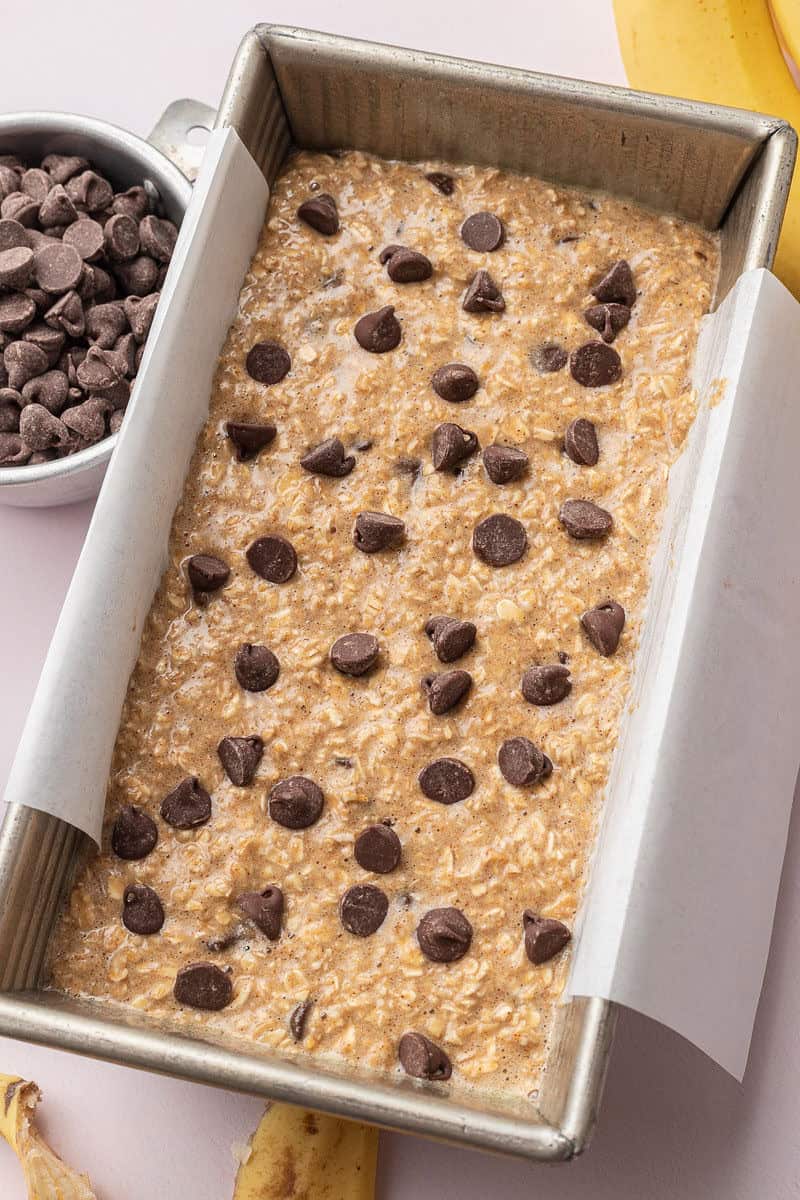 Banana bread batter in pan with chocolate chips on top.