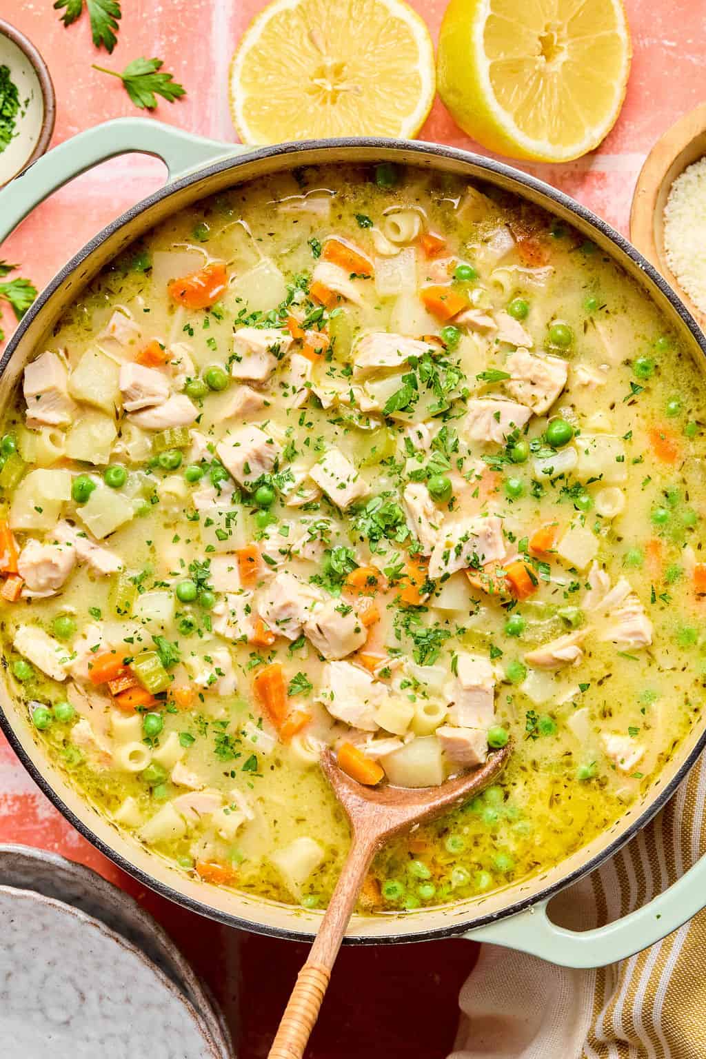 Creamy Chicken Soup in large Dutch oven with wooden spoon.