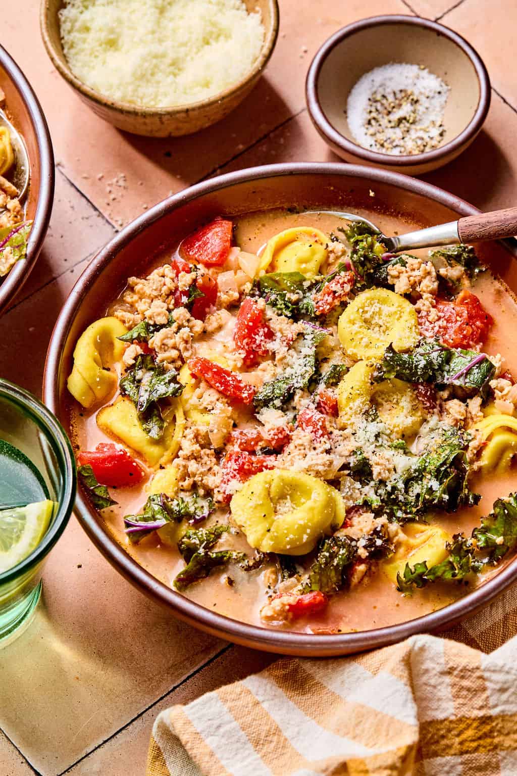 Spicy Sausage Tortellini Soup in bowl with spoon.