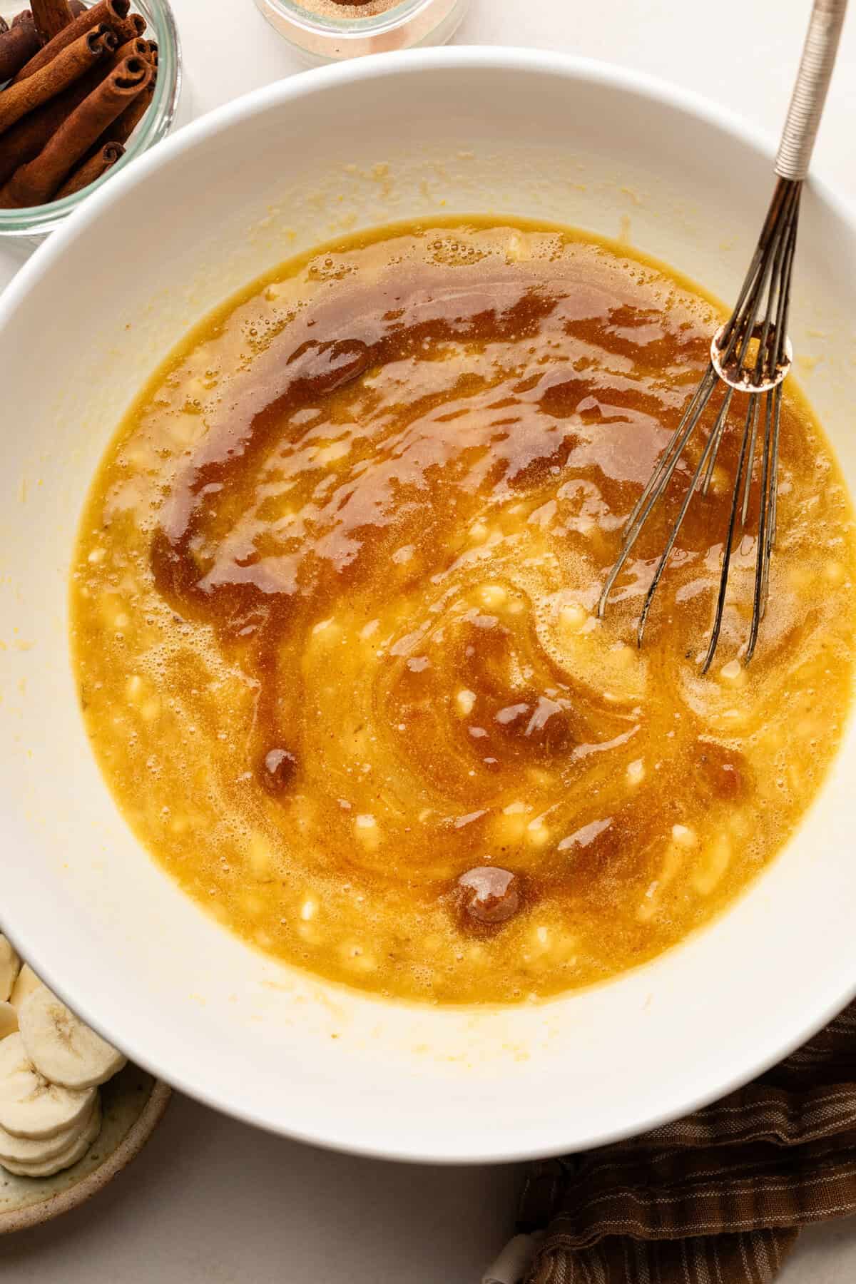 Butter, bananas, eggs, maple syrup and vanilla in large bowl with whisk.