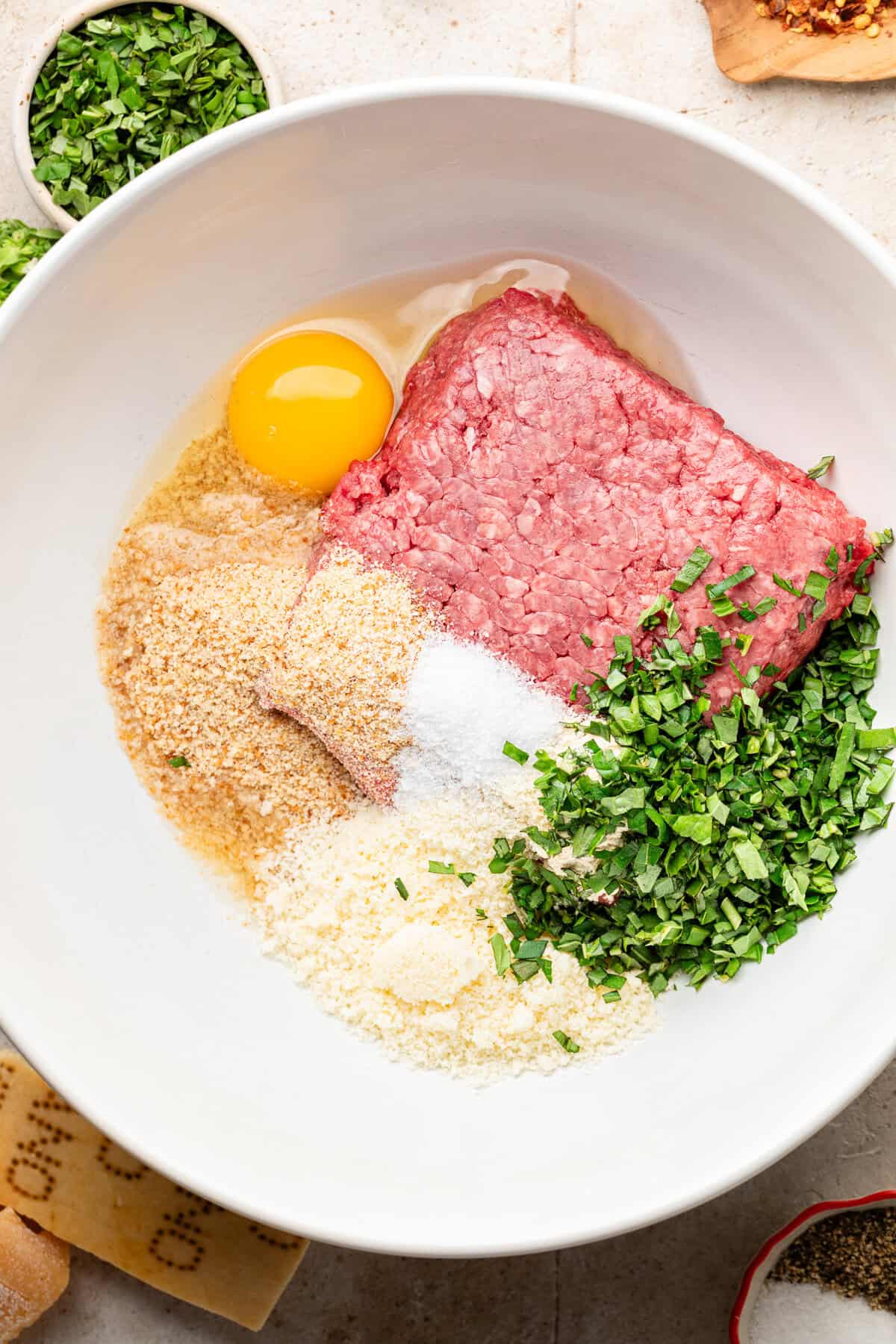 Meatball ingredients in white bowl.
