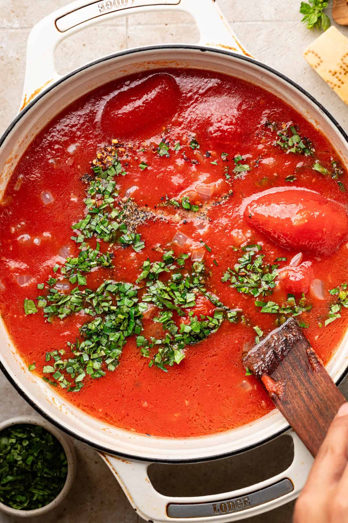 Tomatoes and broth in sauce pan.