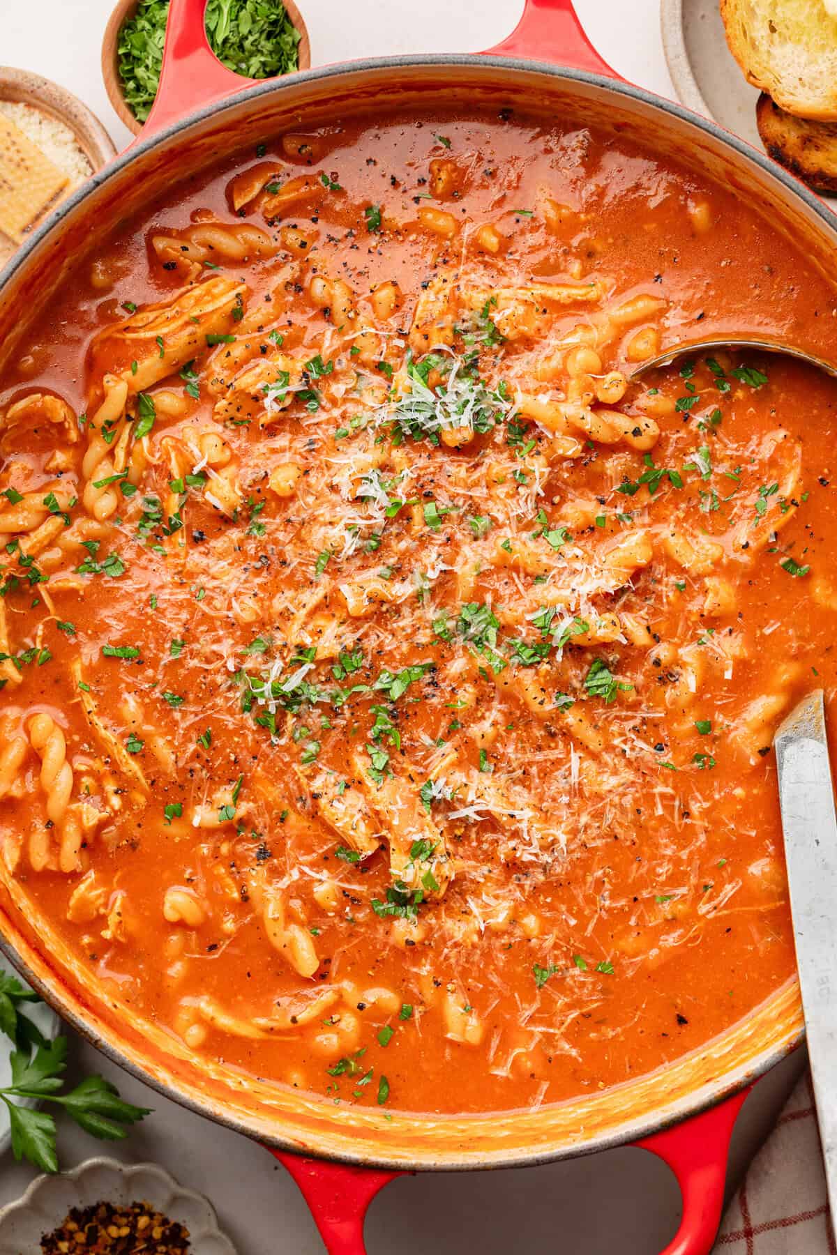 chicken parmesan soup in sauce pot with ladle